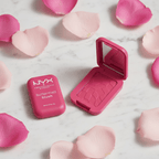 NYX Buttermelt Blush compact on marble surface with rose petals showing cracked texture